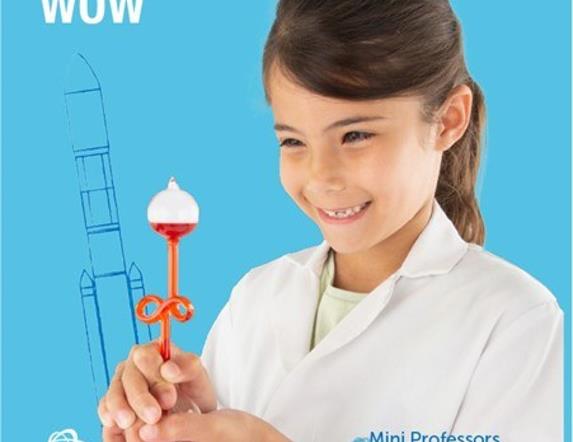 A smiling child holding some science equipment
