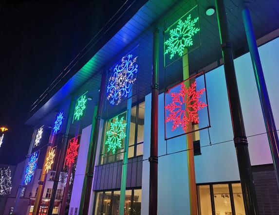 Colourful snowflakes line the side of the Roe Valley Arts & Cultural Centre building