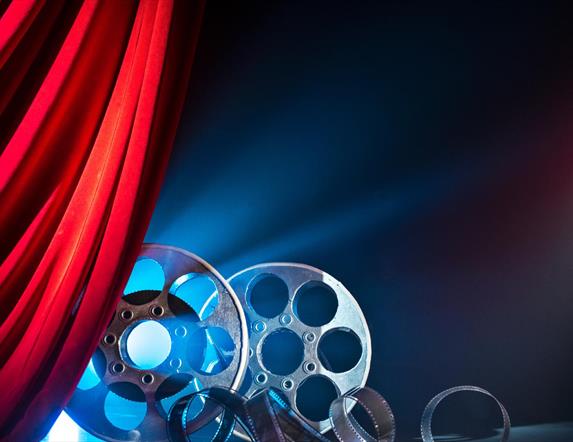 cinema film reels behind a red curtain