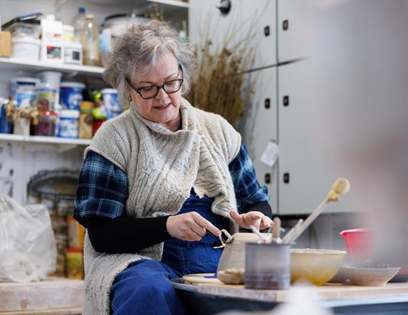 Patricia Millar working on a ceramic piece in her workshop.