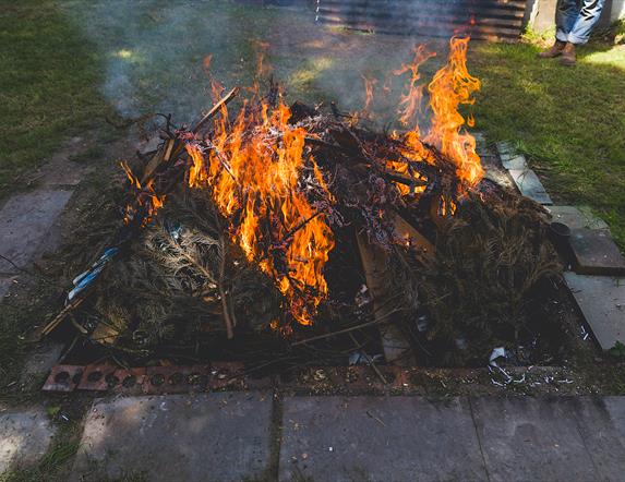 an earthen pit of flames used for firing pottery