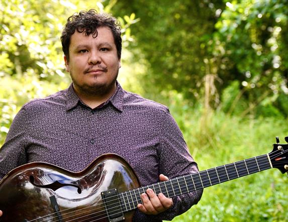 Man holding a traditional string instrument.