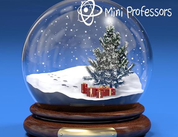 a festive snow globe with a tree and presents inside.