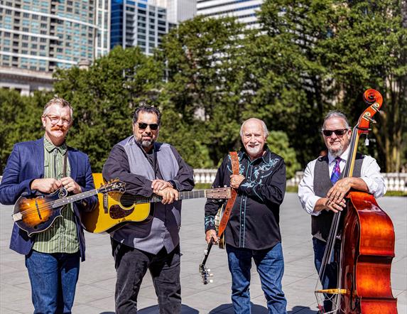 image of Special Consensus standing outside with musical instruments on a bright day