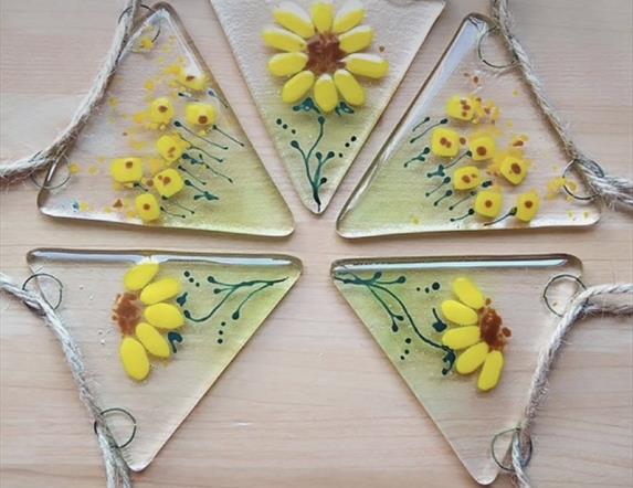 A beautiful glass bunting decorated with painted sunflowers.