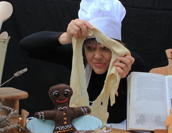 A woman in a chef's hat with pastry.