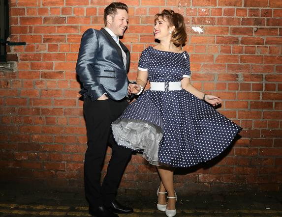 Photo of The Soda Popz in 50's style dress and suit.