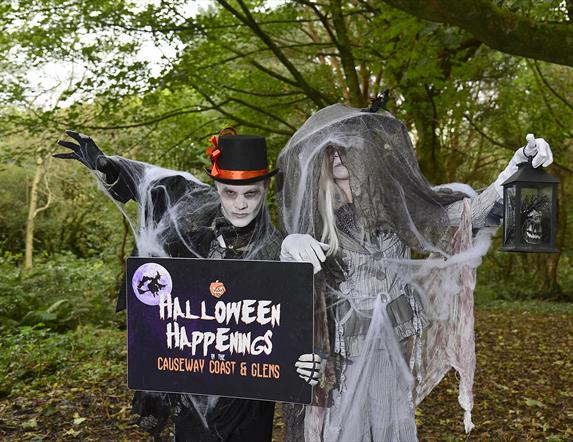 Image shows two spooky characters dressed up in the woods