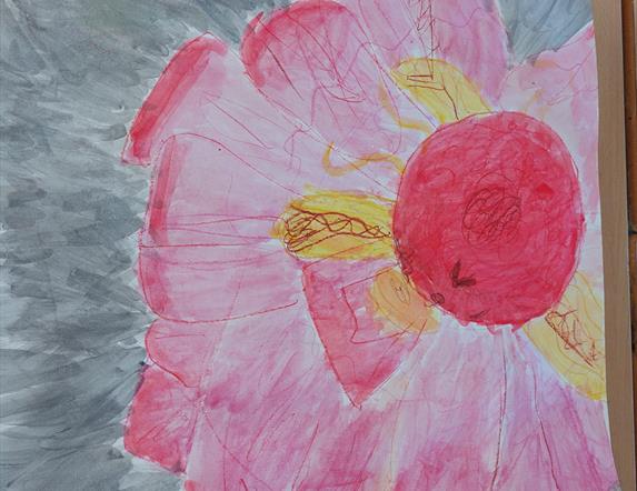 A large hand painted pink flower with some yellow petals.
