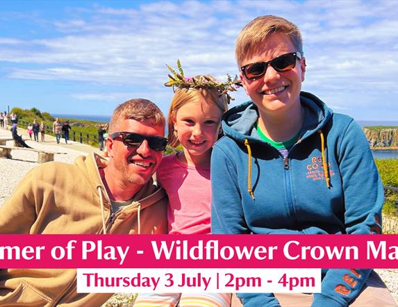 A family pictured enjoying a Wildflower Crown Making session on a sunny day at Carrick-a-Rede