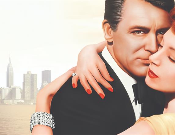 section from movie poster from 'An Affair to Remember' which features a man and woman embracing with the New York City skyline in the distance