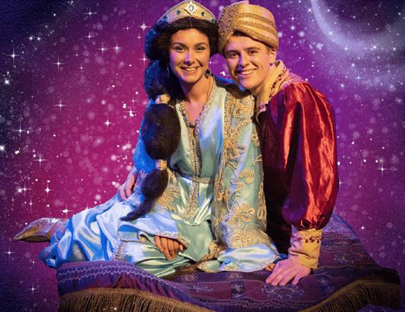 characters Jasmine and Aladdin sit on their magic carpet against a sparkly purple background