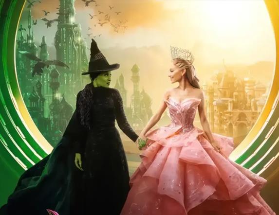 A scene from Wicked with the two main characters Elphaba and Galinda holding hands.