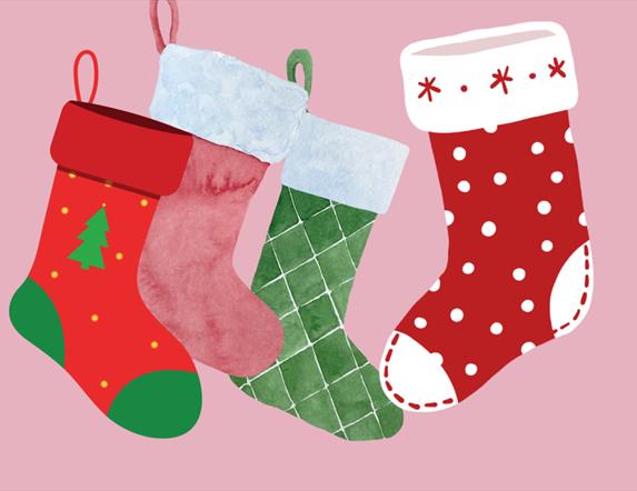 colourful christmas stockings on a pink background