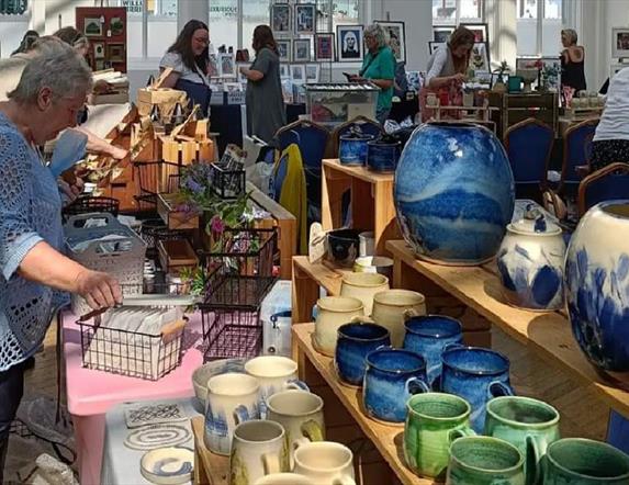 people browsing indoor craft market stalls