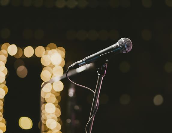 a microphone with blurred lights in the background