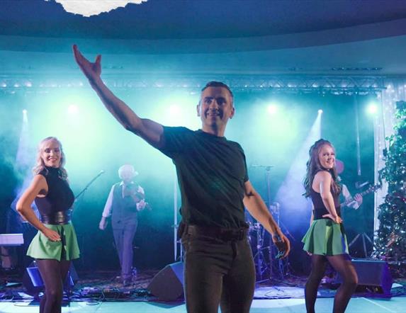 Irish dancers on stage backed by a live band