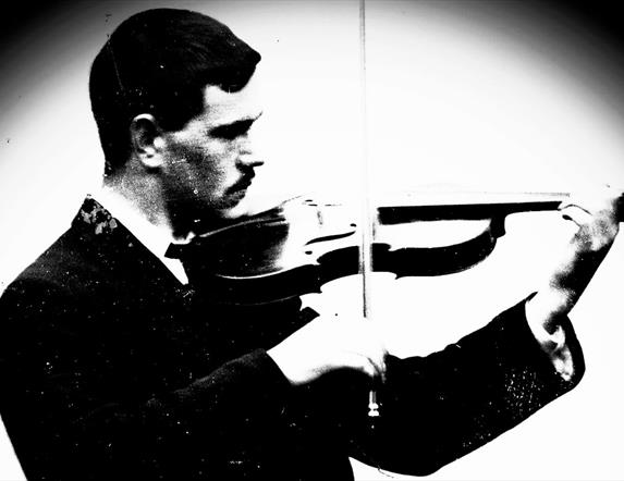 black and white image of Sam Henry playing the violin