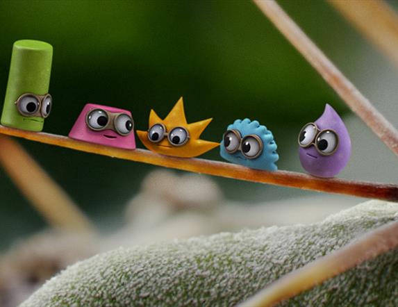 small animated characters wearing glasses sit on a plant