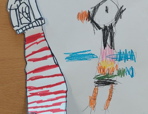 A child's drawing of a colourful puffin accompanied by a cut-out lighthouse.