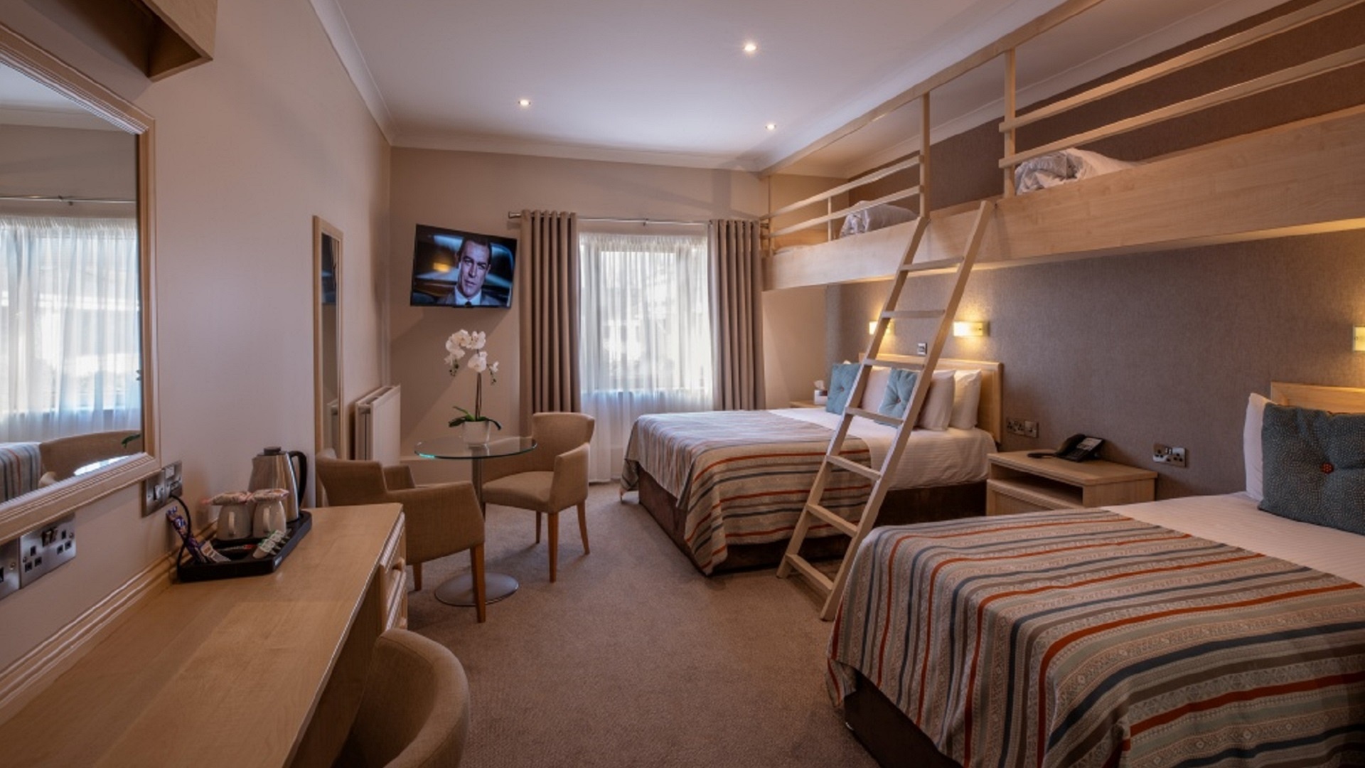 a family room with double bed and bunk beds at the Lodge Hotel in Coleraine