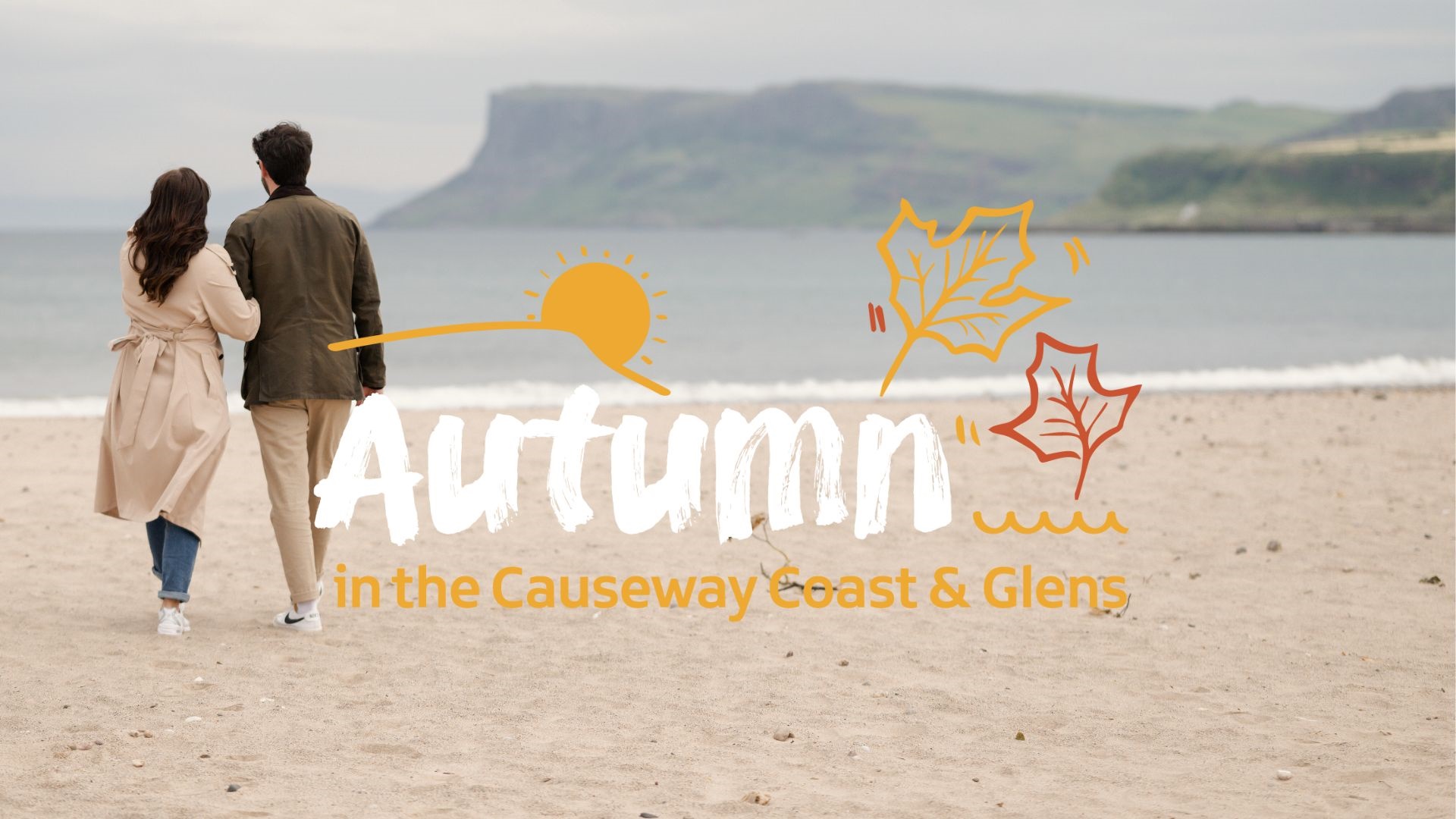 text reads 'Autumn in the Causeway Coast & Glens' with a couple walking on Ballycastle Beach with Fairhead in the distance