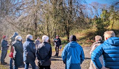 Bob Picken Guiding a group around Downhill Forest wearing outdoor clothing