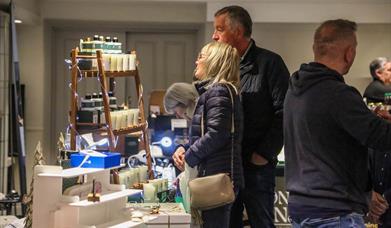 People browsing indoor market stalls