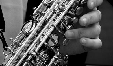 Close up imae ofa saxophone and hands.