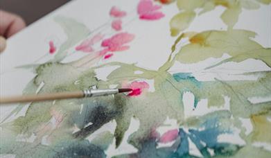 Image  showing a paintbrush with a painting of botanical watercolour art