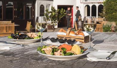 Food and wine on an outside table behind the Bushmills Inn.