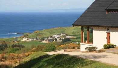 One of our lodges along with the view of the coast.