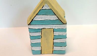a clay beach hut sculpture