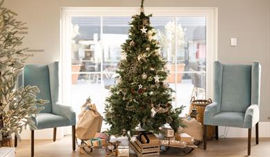 Christmas Tree in Hotel Lobby with presents laid at the base of the tree