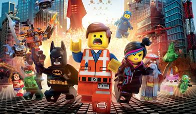 the lego movie poster, showing the main character running from an explosion surrounded by other Lego characters