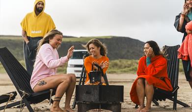 people relax around the fire pit