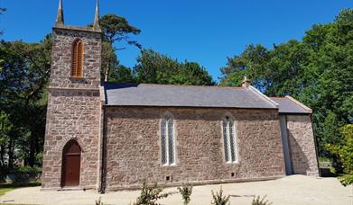 Old stone church building with blue sky beyond