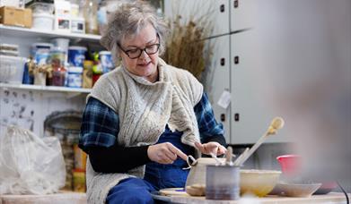Patricia Millar working on a ceramic piece in her workshop.