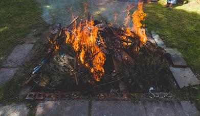 an earthen pit of flames used for firing pottery