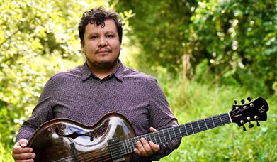 Man holding a traditional string instrument.