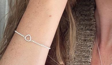 a silver bracelet on a woman's arm