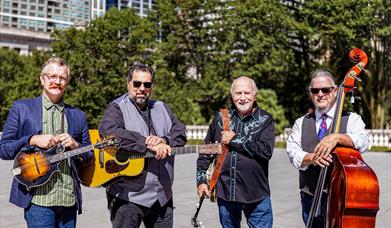 image of Special Consensus standing outside with musical instruments on a bright day