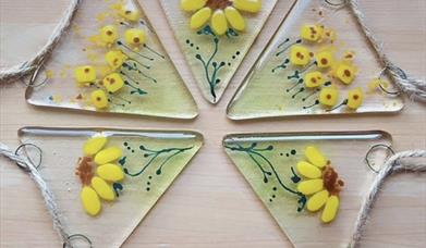 A beautiful glass bunting decorated with painted sunflowers. 
