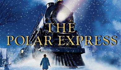 still from the movie 'The Polar Express' which depicts a small boy looking up towards an old-fashioned train as the snow falls down
