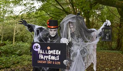 Image shows two spooky characters dressed up in the woods