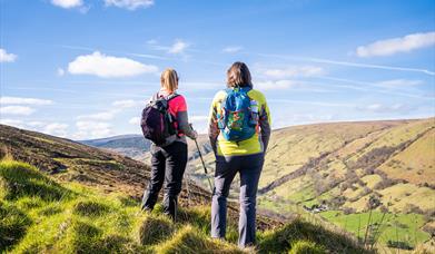 2 hikers take in the views of the surrounding countryside