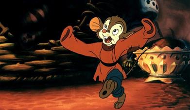 Picture of a small  mouse wearing clothes and leaping in the air