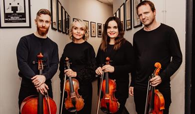 the archo string quartet with their instruments