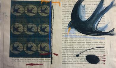 Image of a painted bird, a swallow on the pages of a book.