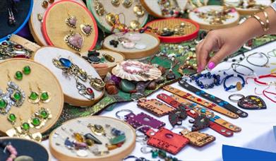 a selection of crafted jewellery displayed on a table